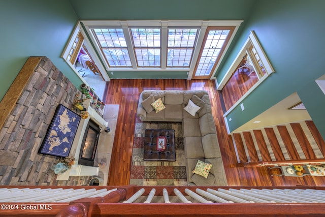 living room with a towering ceiling and hardwood / wood-style floors