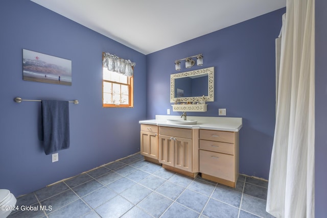 full bathroom with tile patterned floors, toilet, and vanity