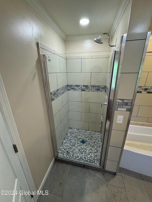 bathroom featuring a tile shower and crown molding