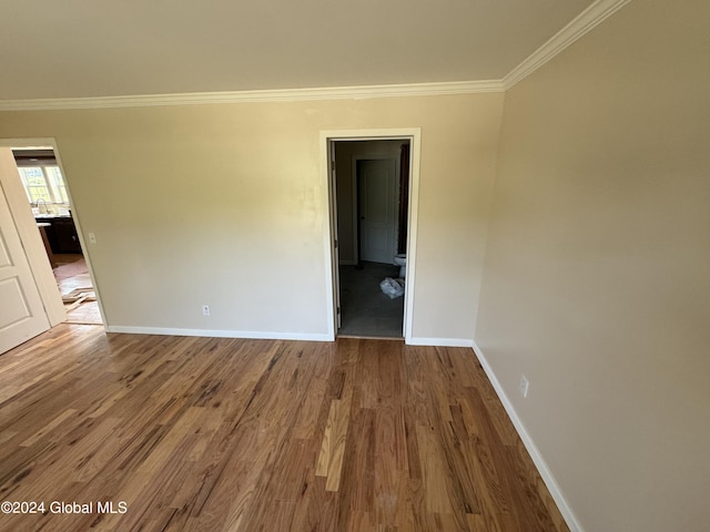 unfurnished room featuring ornamental molding and hardwood / wood-style flooring