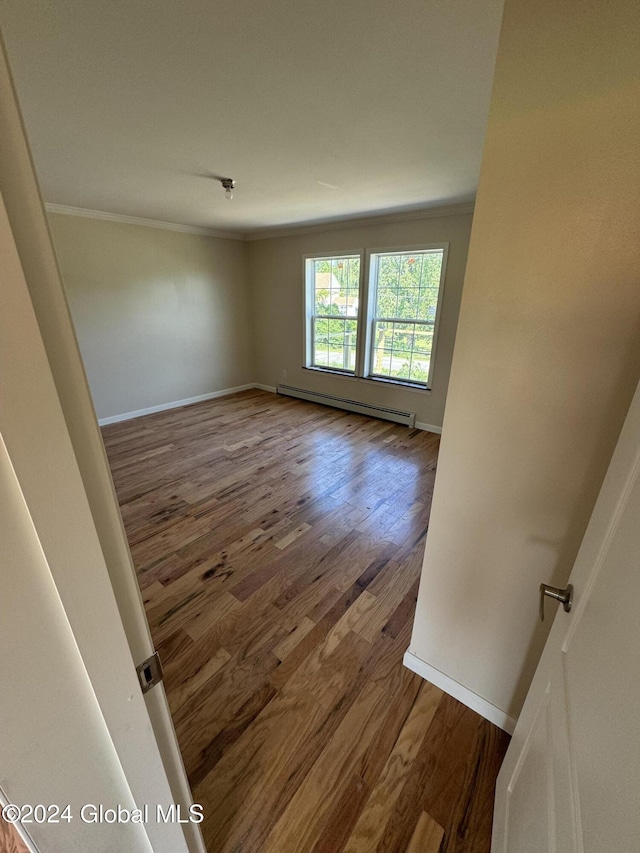 spare room featuring dark hardwood / wood-style floors and baseboard heating