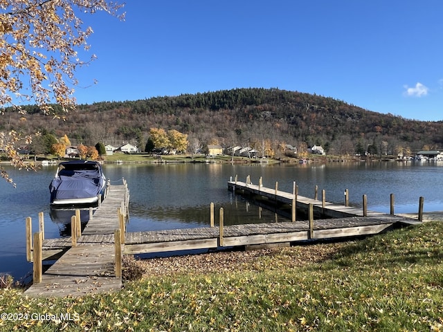 dock area featuring a water and mountain view