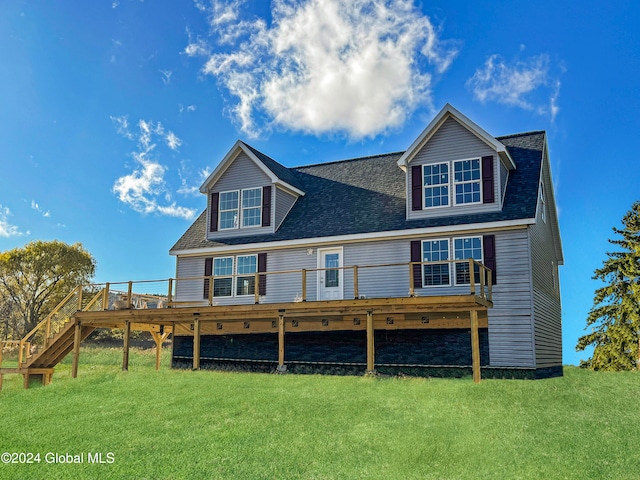 back of property with a yard and a wooden deck