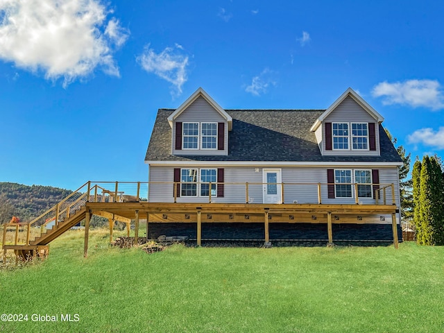 back of house featuring a lawn and a wooden deck