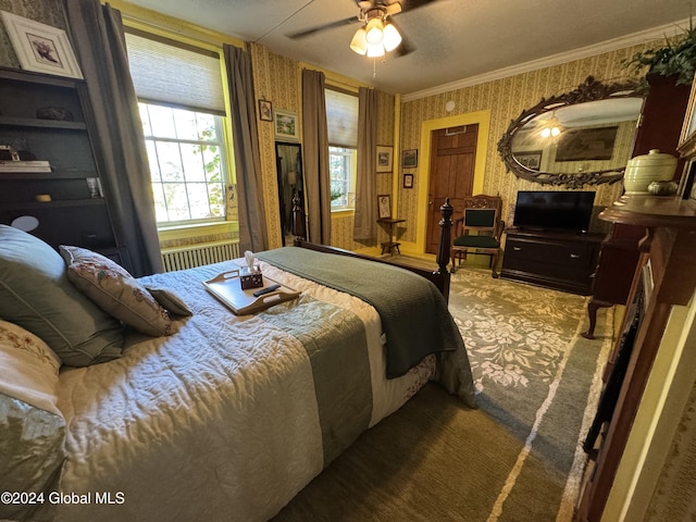 carpeted bedroom featuring wallpapered walls, crown molding, and ceiling fan
