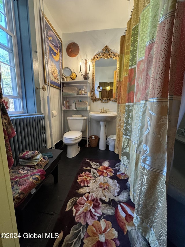 full bathroom with toilet and radiator