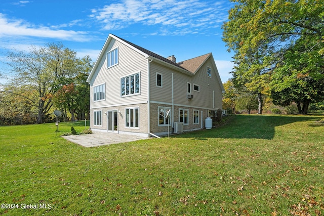 rear view of house featuring cooling unit, a yard, and a patio area