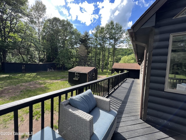 wooden terrace featuring a storage shed