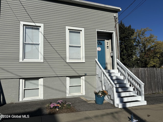 view of exterior entry with a patio area