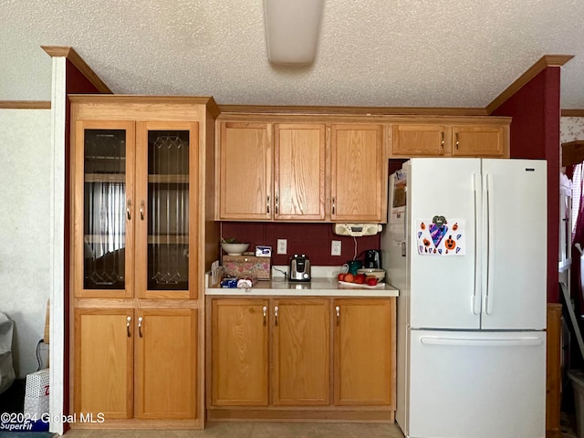 kitchen with a textured ceiling and white refrigerator