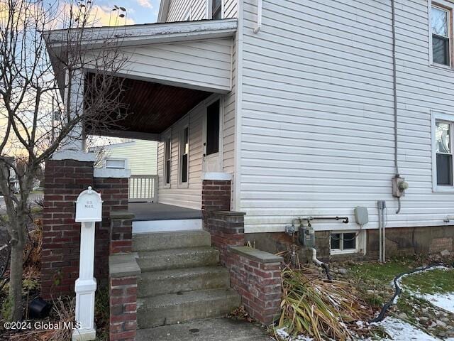 view of side of home with covered porch