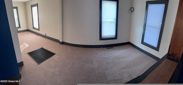 carpeted empty room featuring a healthy amount of sunlight