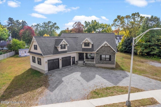 view of front of property with a garage and a front lawn