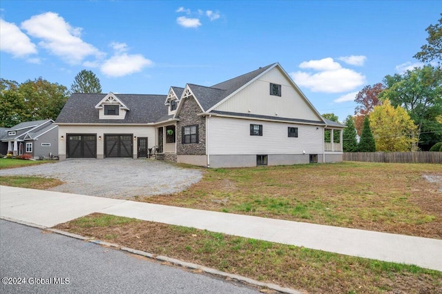 view of front of house with a front yard and a garage