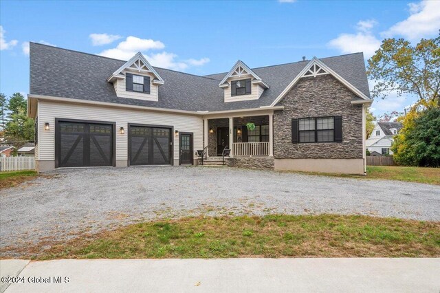 view of front of home with a garage and a porch