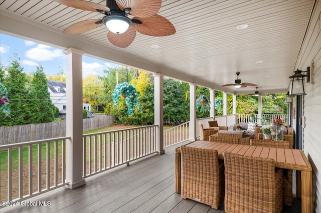 wooden deck with ceiling fan and outdoor lounge area