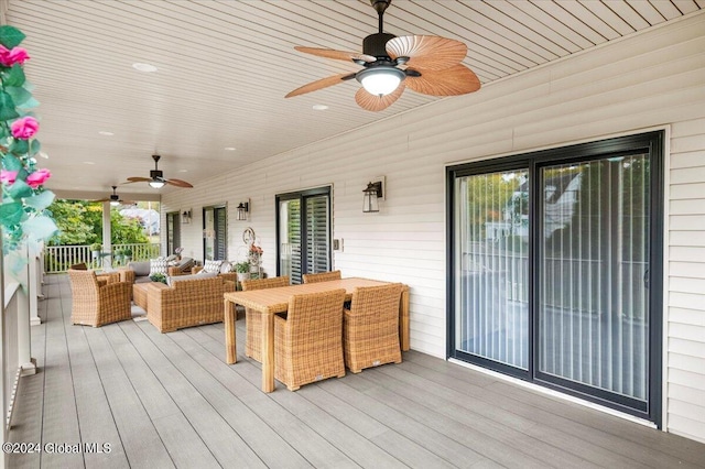 wooden deck featuring ceiling fan and an outdoor living space