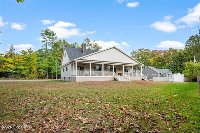 view of front of home with a front yard and covered porch