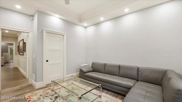 living room with ornamental molding and hardwood / wood-style floors