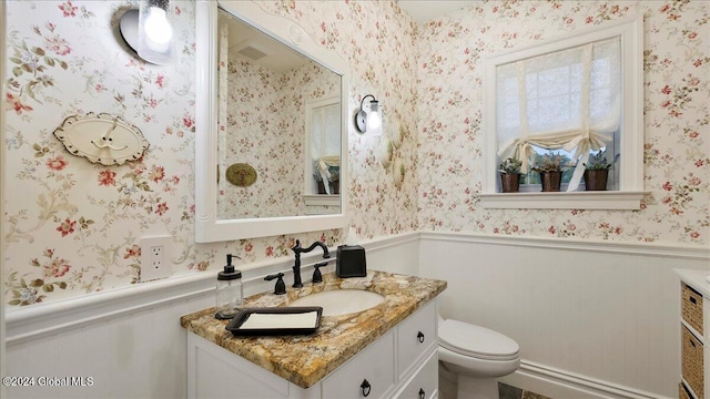 bathroom featuring vanity and toilet