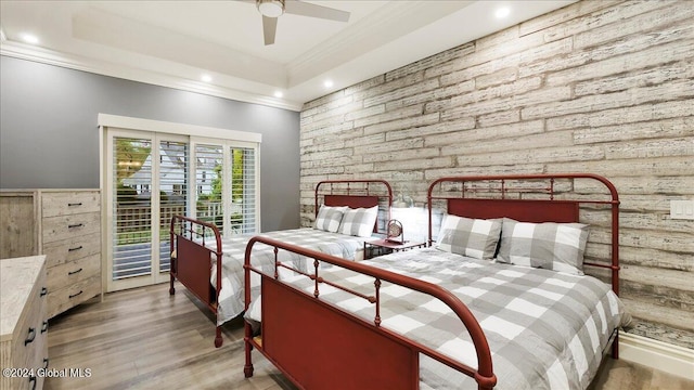 bedroom featuring ceiling fan, hardwood / wood-style flooring, access to outside, and ornamental molding