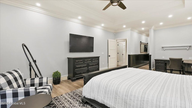 bedroom with light hardwood / wood-style flooring, ornamental molding, and ceiling fan