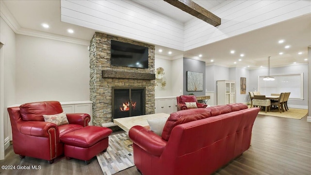 living room with crown molding, dark hardwood / wood-style floors, beamed ceiling, and a fireplace