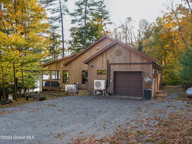 view of front of home with ac unit and a garage