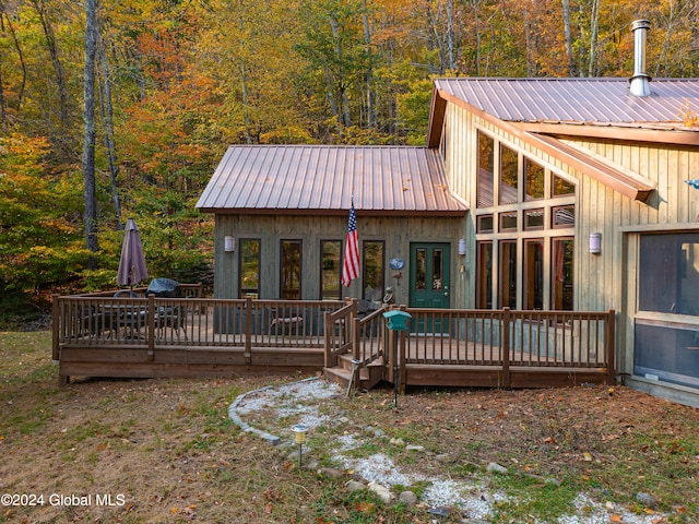 rear view of house featuring a deck and french doors