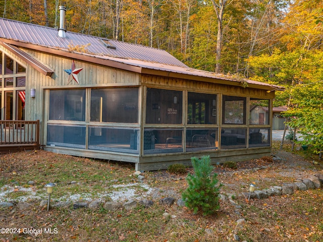 back of house featuring a sunroom