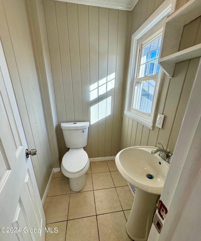 bathroom with toilet and tile patterned flooring