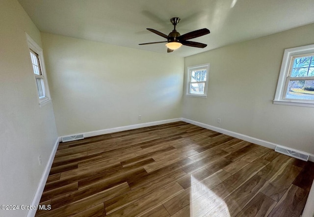 unfurnished room with ceiling fan and dark hardwood / wood-style flooring