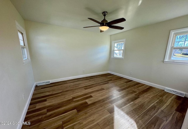 unfurnished room featuring dark wood-type flooring and ceiling fan