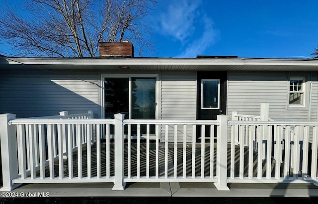 rear view of house featuring a wooden deck