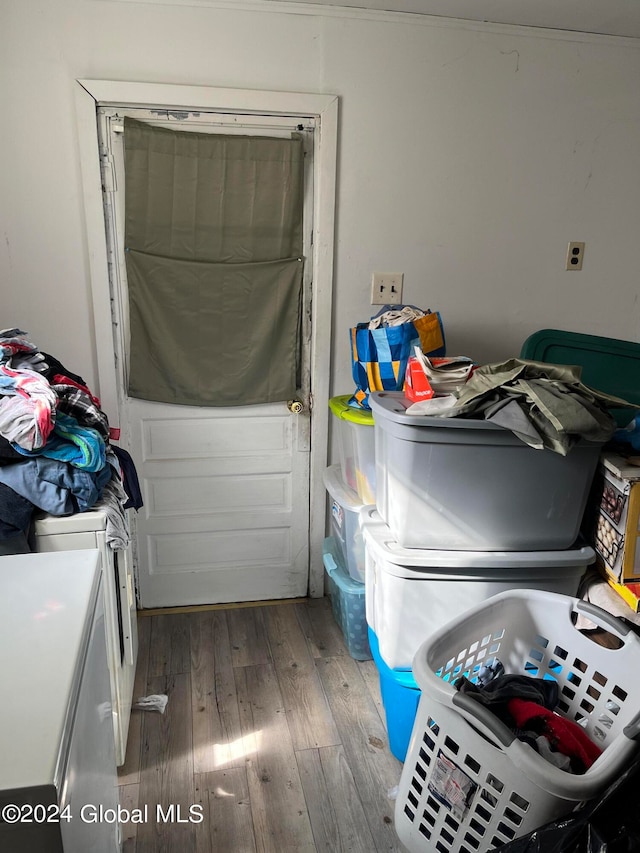 clothes washing area featuring washer and dryer and hardwood / wood-style floors