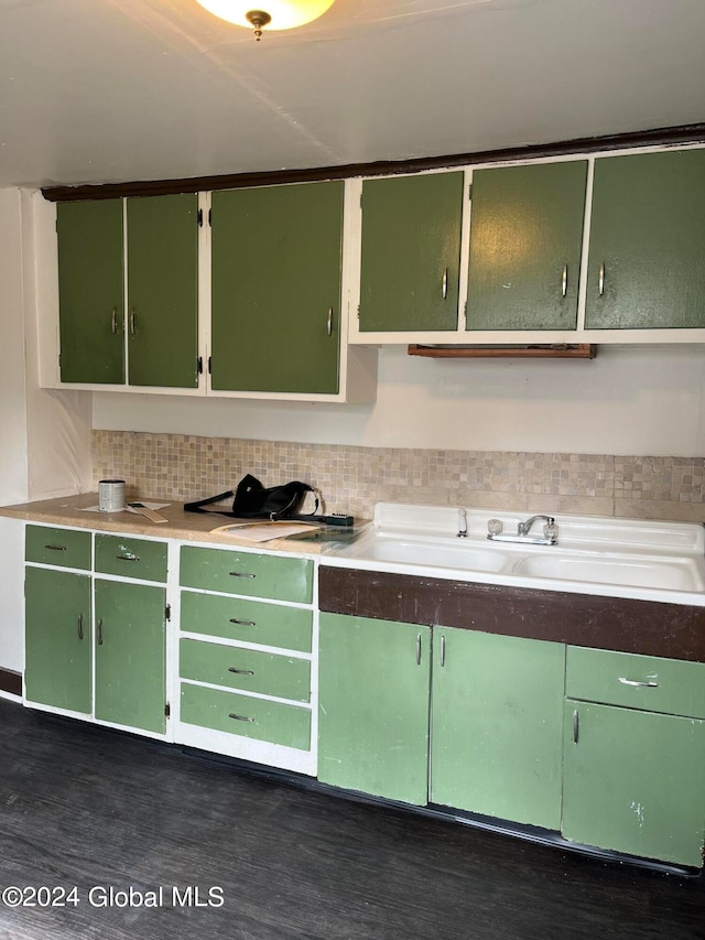 kitchen featuring tasteful backsplash, green cabinets, and dark hardwood / wood-style flooring