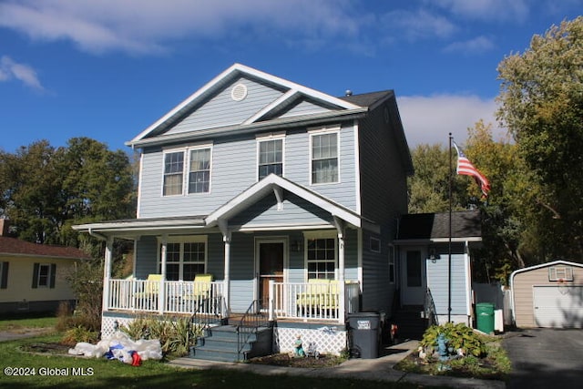 view of front of house with a garage, an outdoor structure, and covered porch