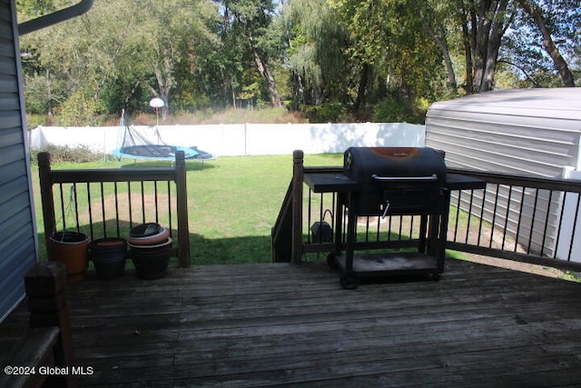 wooden terrace featuring a yard