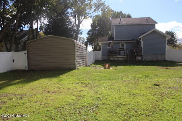 view of yard with a storage shed and a wooden deck