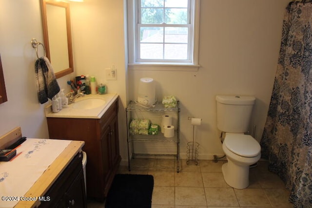 bathroom featuring toilet, tile patterned flooring, and vanity