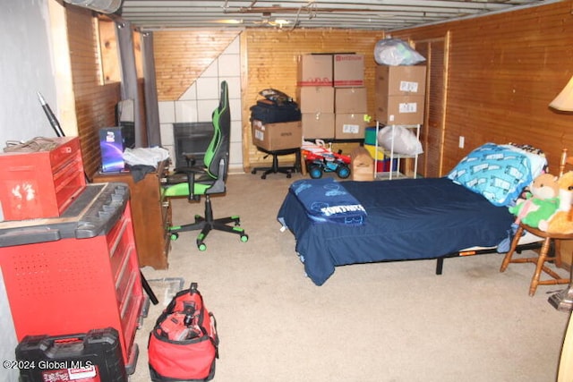 bedroom with brick wall, carpet, and wooden walls