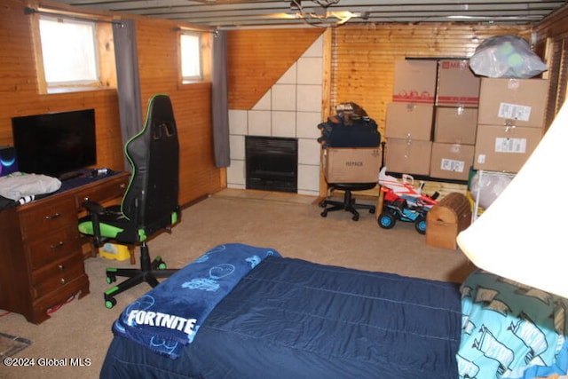 bedroom with wooden walls and carpet flooring