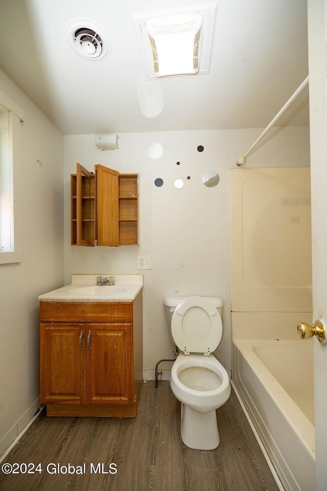 full bathroom with vanity, bathtub / shower combination, toilet, and wood-type flooring