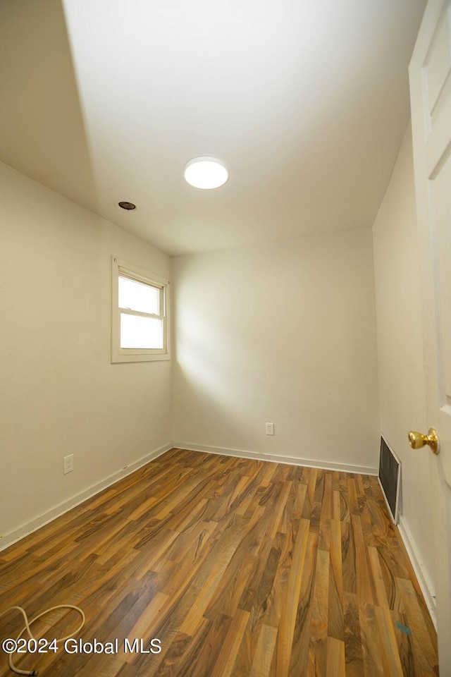 spare room with dark hardwood / wood-style floors