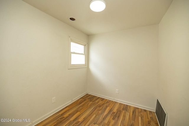 empty room with dark hardwood / wood-style flooring