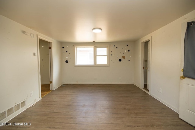 unfurnished room with dark hardwood / wood-style floors