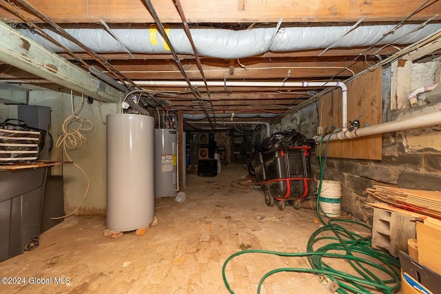 basement featuring gas water heater and electric water heater