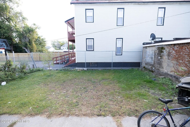 back of property featuring a yard