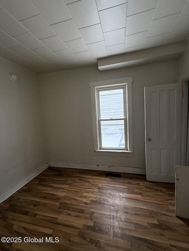 unfurnished room featuring dark hardwood / wood-style floors