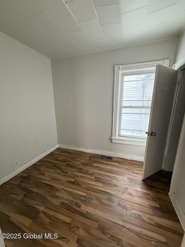 empty room with dark wood-type flooring